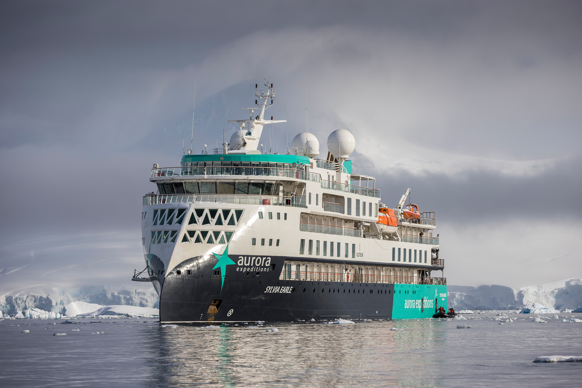 A modern expedition cruise ship navigating through icy Antarctic waters, surrounded by glaciers