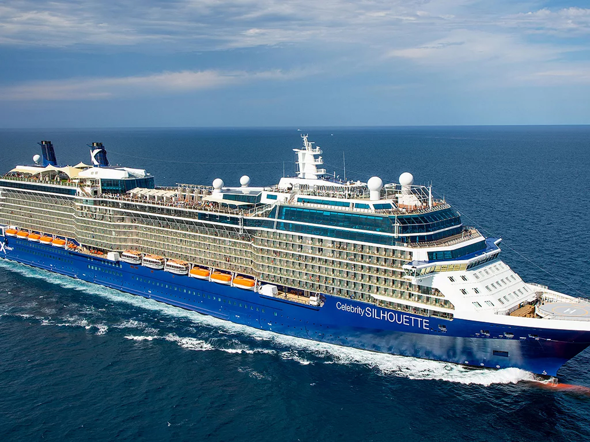 Celebrity Silhouette Cruise Ship at Sea A large, modern Celebrity Cruise Lines ship sailing across blue ocean waters, showcasing its sleek