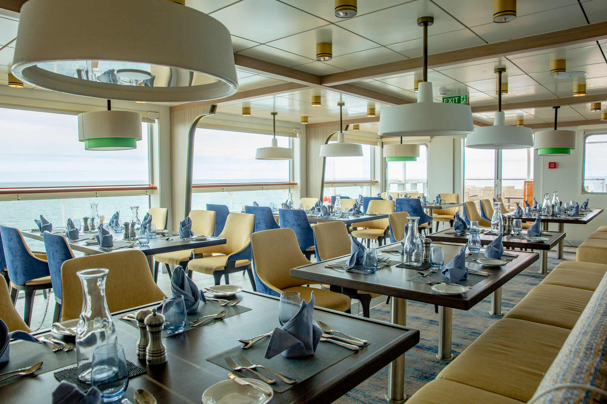 Cruise ship dining room with ocean view aboard Aurora Expeditions vessel