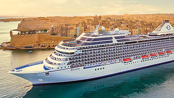 Cruise Ship Docked in Mediterranean Port Oceania cruise ship docked in a Mediterranean port with golden stone buildings