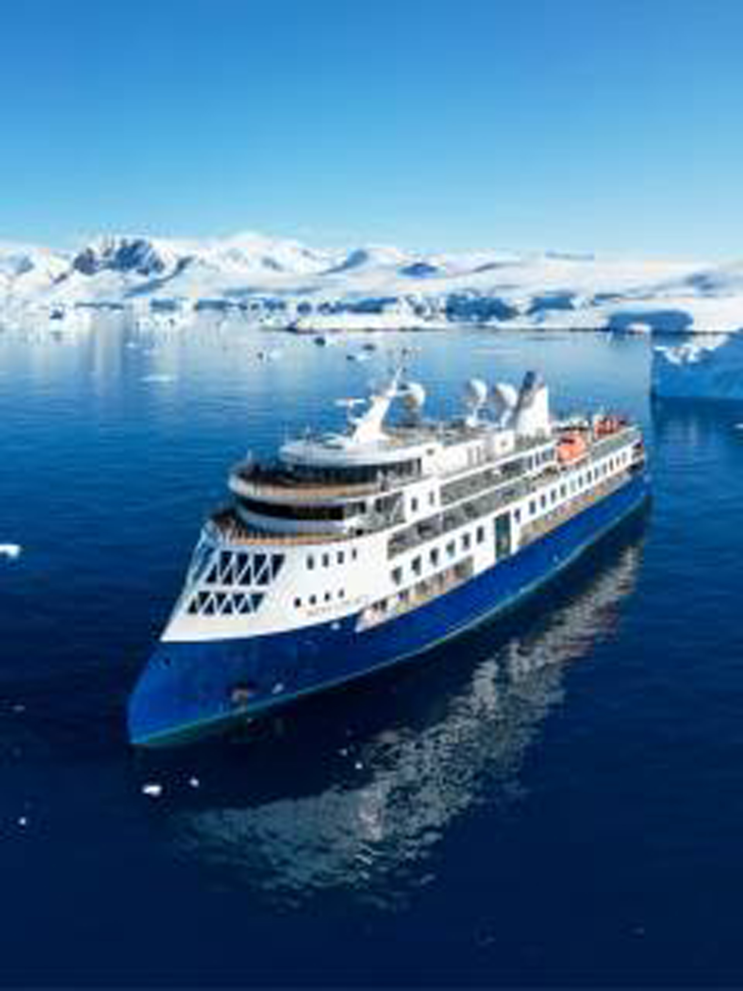 Cruise Ship Navigating Icy Arctic Waters A modern expedition cruise ship sailing through a pristine polar seascape with snow-covered