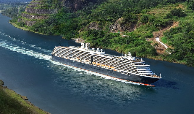 Cruise Ship Navigating Scenic Canal Passage A large modern cruise ship sailing through a lush, green narrow waterway with rocky cliff sides