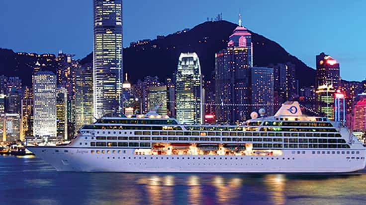 Cruise Ship in Hong Kong Harbor at Night Oceania cruise ship docked in Victoria Harbor with Hong Kong skyline at twilight