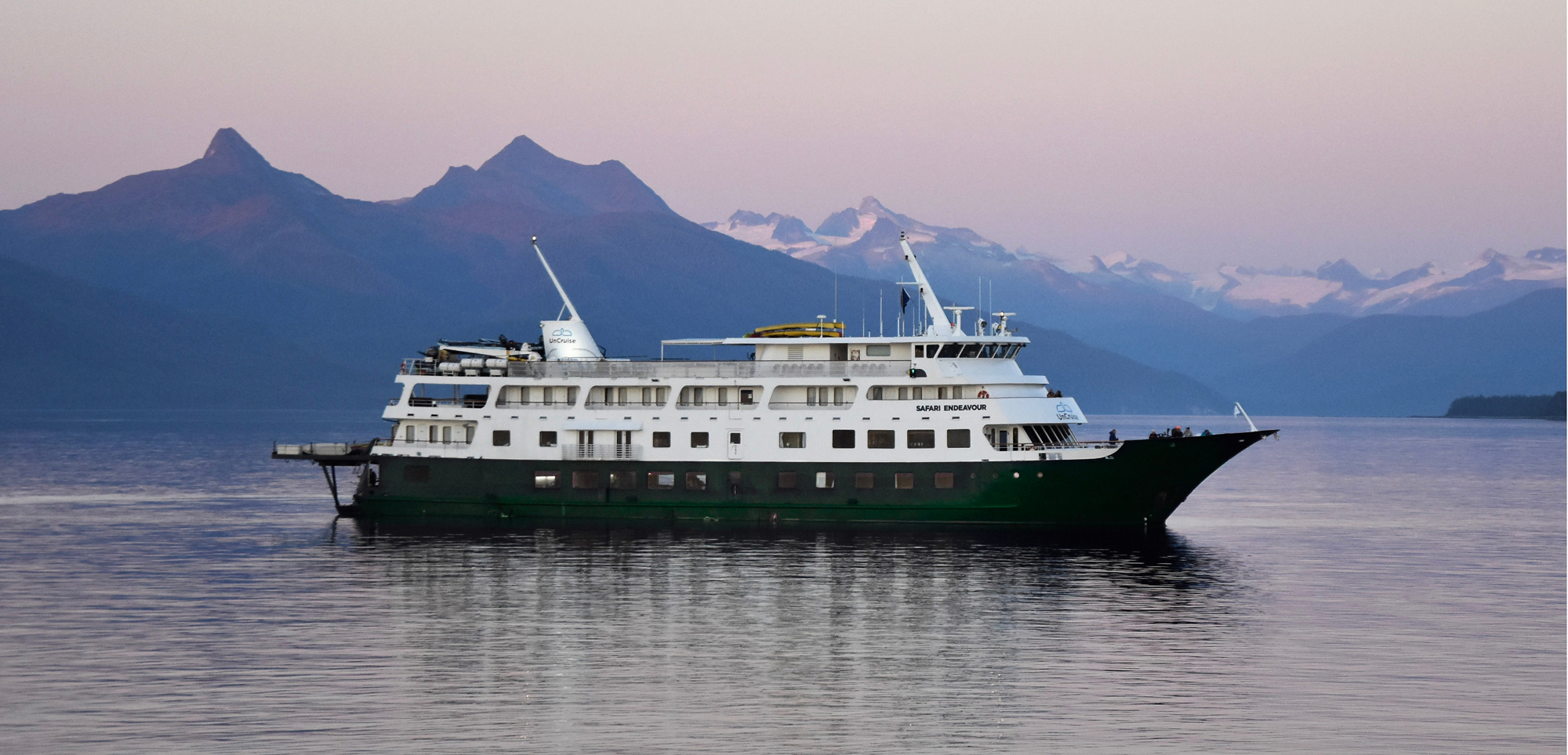 Cruise Ship in Scenic Mountain Fjord Safari Endeavour expedition cruise ship in glacier bay with snow-capped mountains