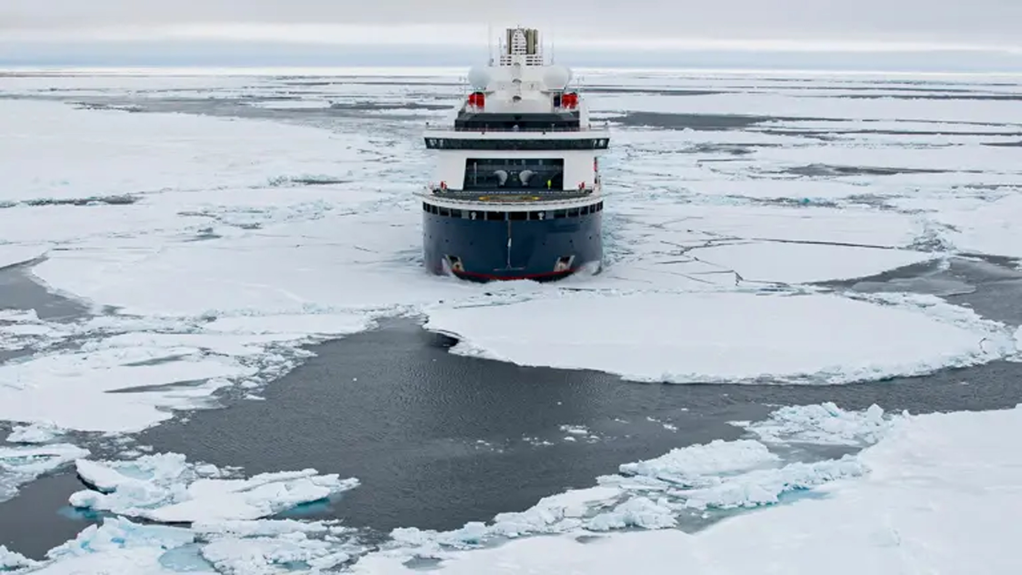 Icebreaker Navigating Arctic Frozen Waters A sturdy icebreaker ship cutting through thick sea ice in a polar region, creating a distinctive