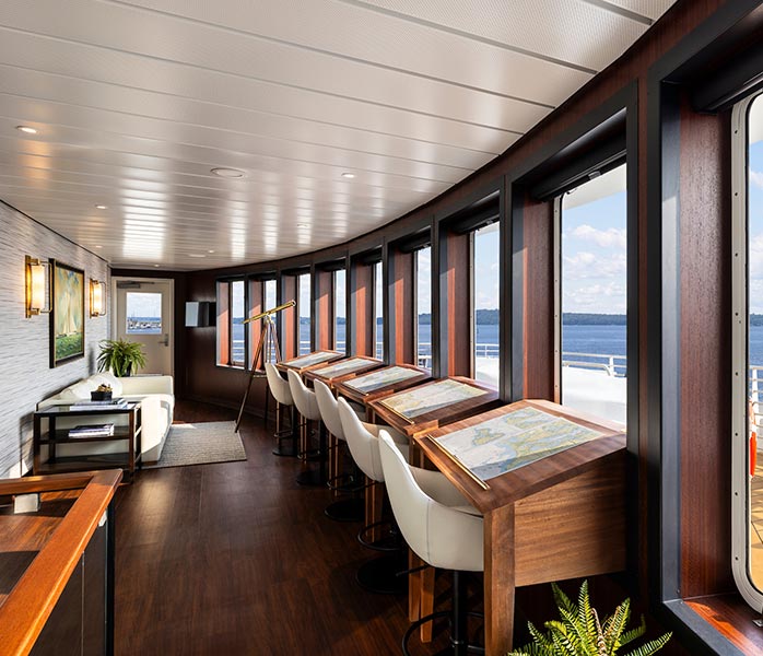 Luxury Cruise Ship Observation Lounge with Ocean Views An elegant observation lounge aboard a cruise ship featuring floor-to-ceiling windows overlooking the ocean