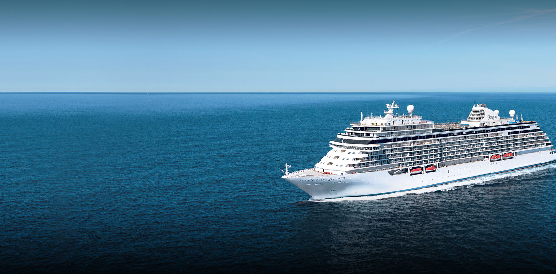 Regent Seven Seas cruise ship sailing across tranquil blue ocean