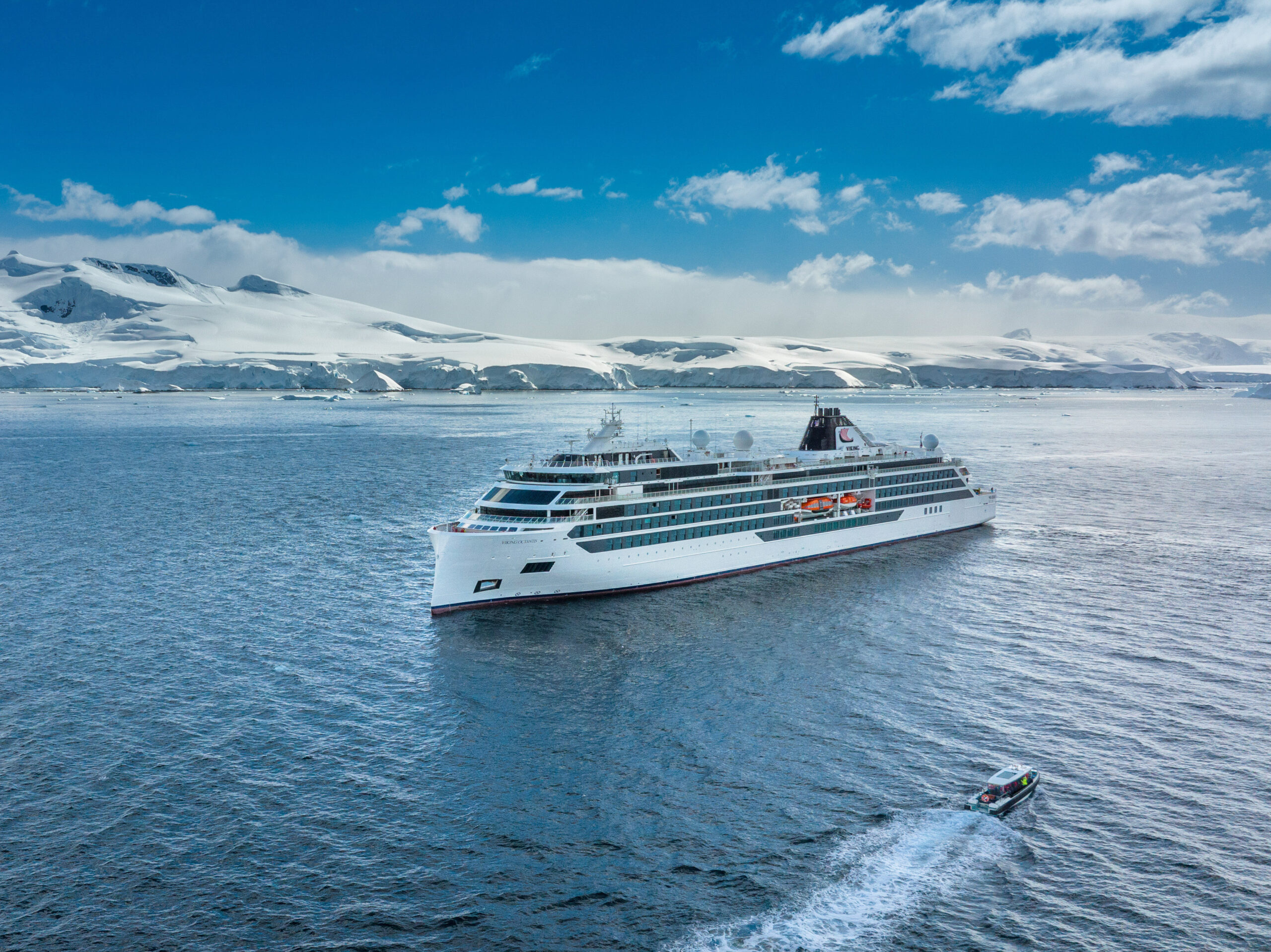 Viking Ocean ship sailing through Antarctic waters with snow-covered mountains