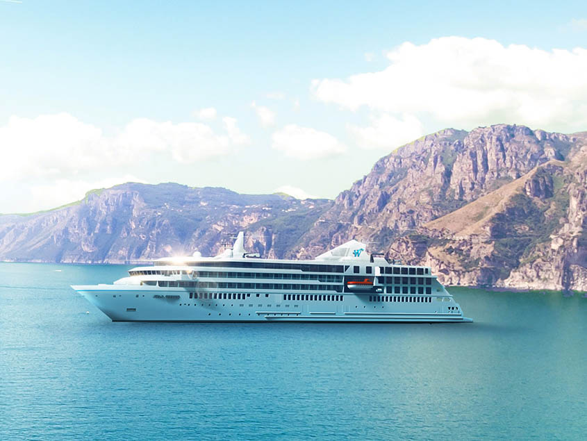 Windstar Star Plus Class cruise ship sailing through turquoise waters with dramatic rocky mountains