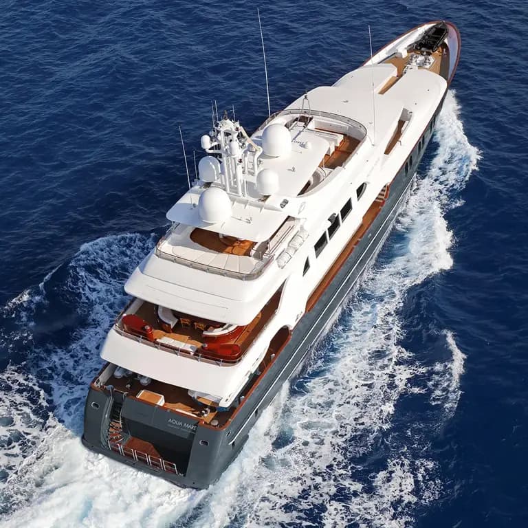 Luxury Yacht Cruising Deep Blue Waters A sleek white multi-level luxury yacht cutting through deep blue ocean waters, showcasing its