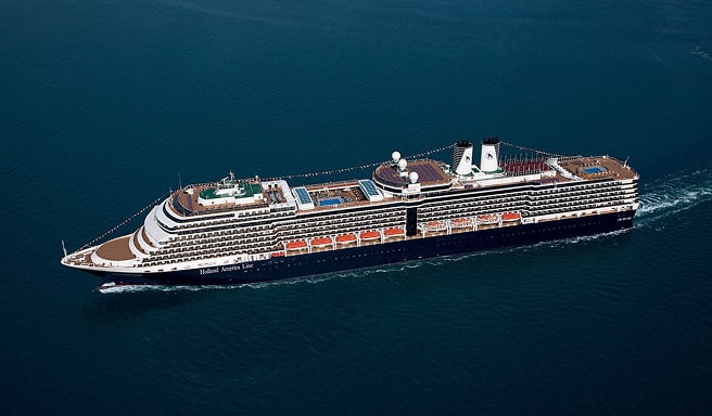 Modern Cruise Ship on Open Ocean A large, contemporary cruise ship sailing smoothly across deep blue waters, showcasing multiple