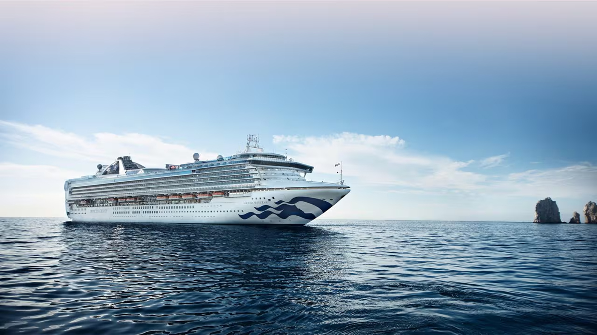 Princess cruise ship sailing near Cabo San Lucas with rocky coastal formations
