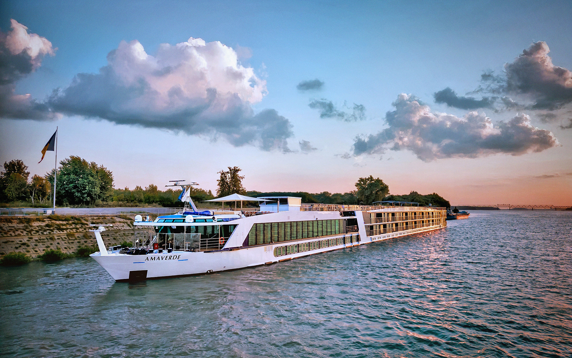 AmaVerde river cruise ship docked along a river at sunset