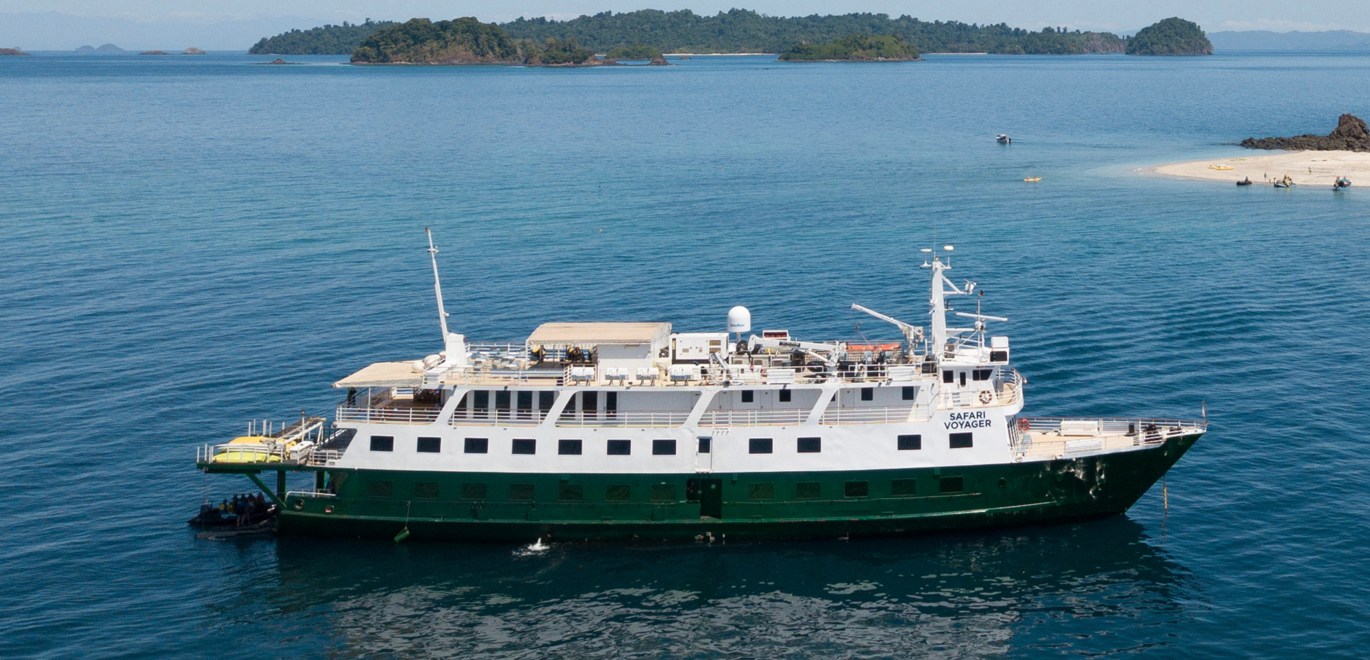 Safari Voyager Expedition Cruise in Tropical Waters Safari Voyager expedition cruise ship anchored in tropical waters near sandy beach