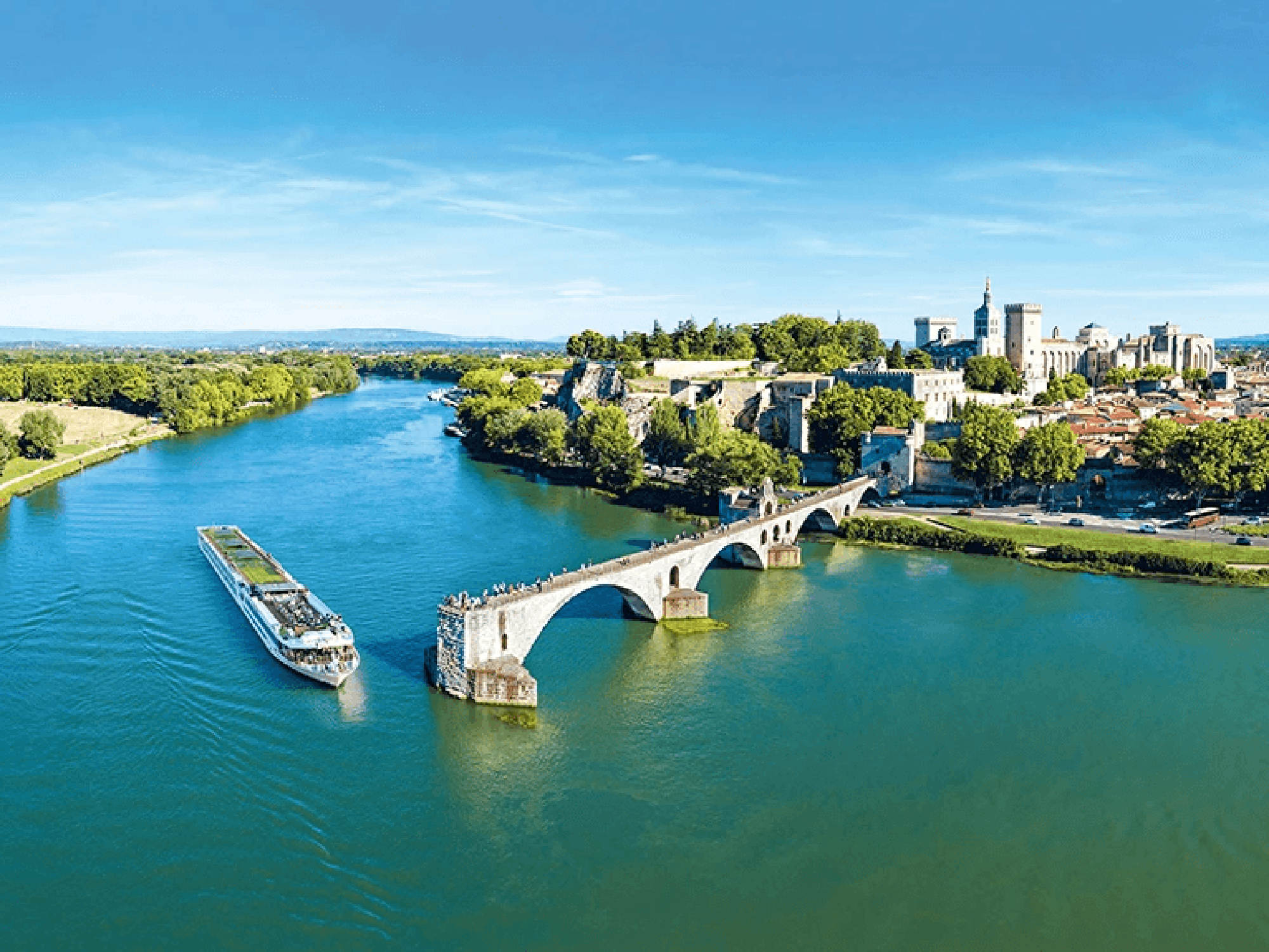 River cruise ship near the historic Pont d'Avignon with the medieval city in the background