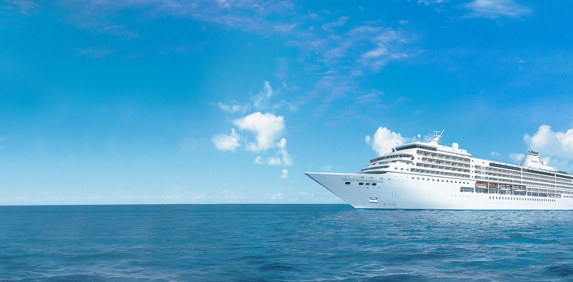 Regent Seven Seas luxury cruise ship sailing on calm blue ocean