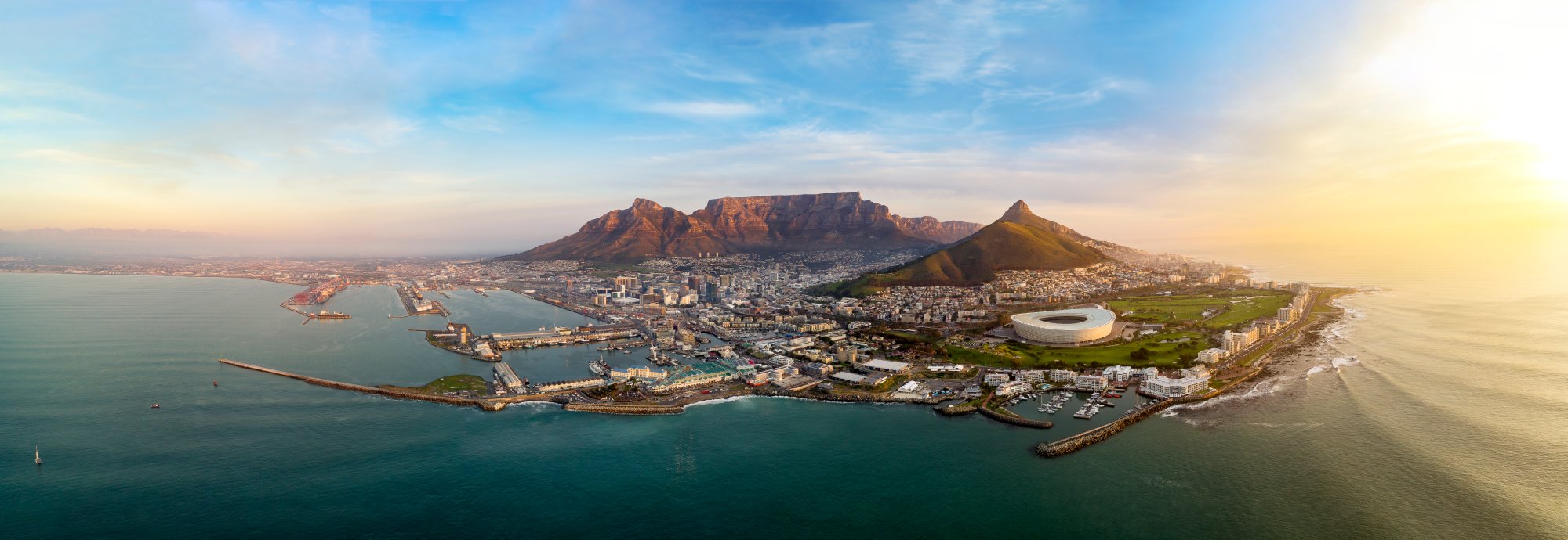 Cape Town Aerial View with Table Mountain An expansive aerial photograph of Cape Town, South Africa at sunset, showcasing Table Mountain