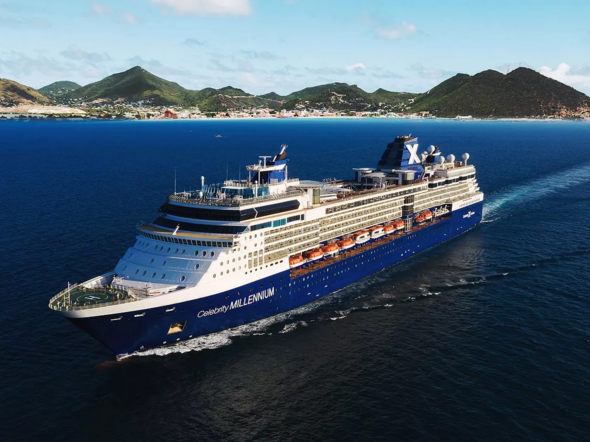 Celebrity Millennium Cruise Ship at Tropical Port The Celebrity Millennium, a large modern cruise ship with distinctive blue hull and white