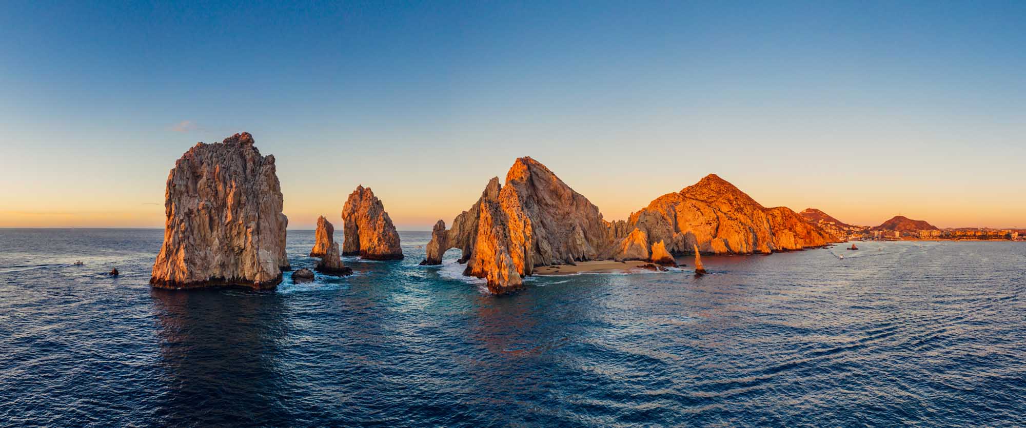El Arco Rock Formation at Sunrise, Cabo San Lucas A stunning panoramic aerial view of the iconic El Arco (The Arch) rock formation at Cabo San Lucas