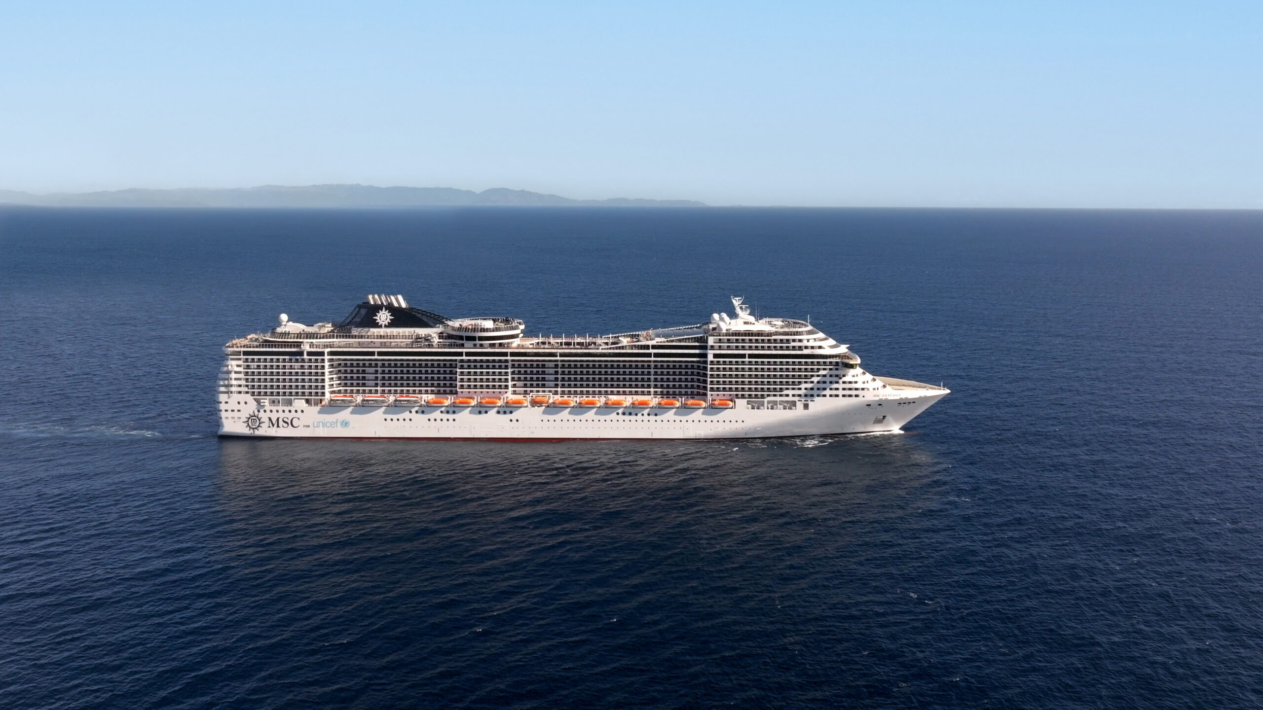 MSC Fantasia cruise ship sailing through calm blue waters