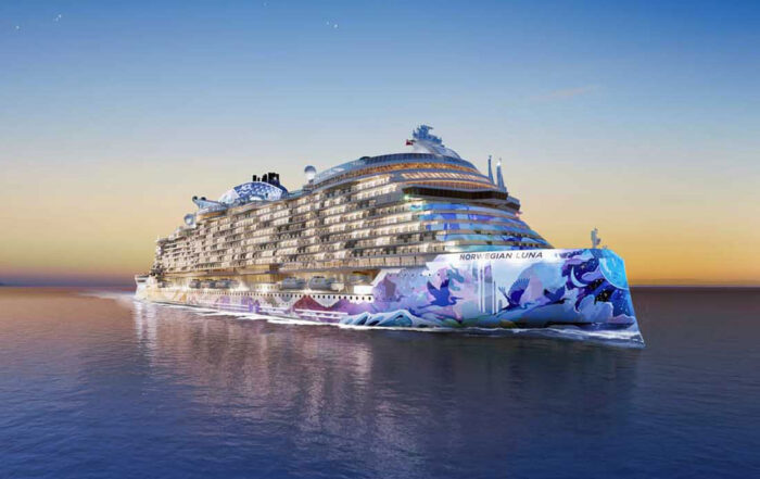 Norwegian Luna cruise ship at dusk with illuminated hull on calm ocean
