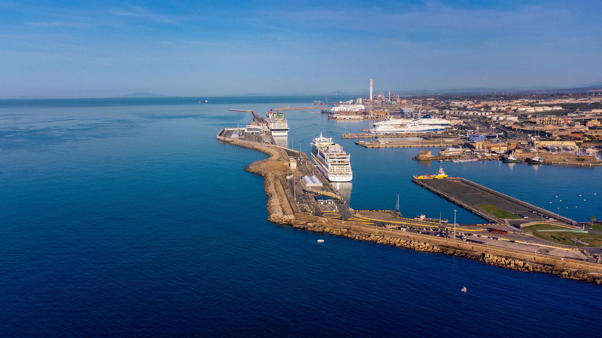An expansive aerial view of Civitavecchia port in Italy, showcasing multiple large cruise ships