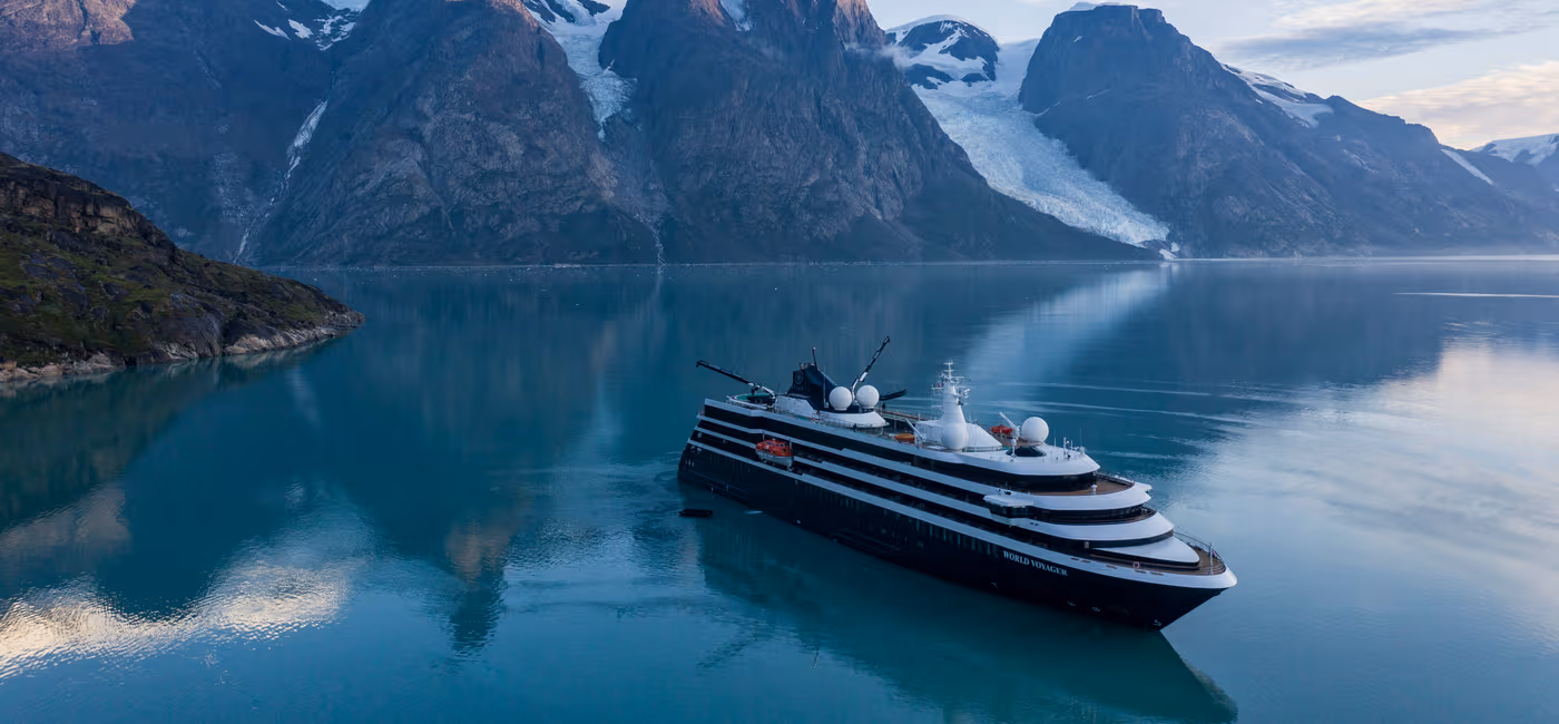 Viking Octantis expedition ship navigating pristine Antarctic waters among massive icebergs