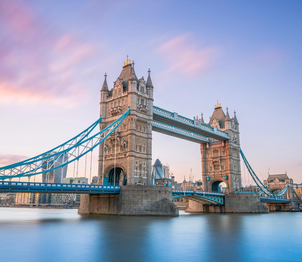 An iconic view of Tower Bridge spanning the River Thames in London, England, captured during golden