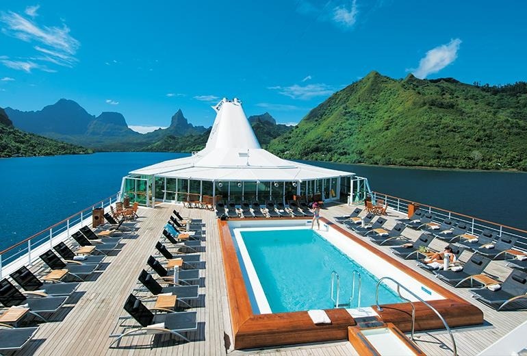 Paul Gauguin cruise ship anchored in turquoise Polynesian lagoon